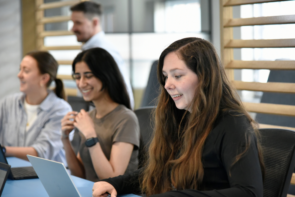 People smiling at their laptop