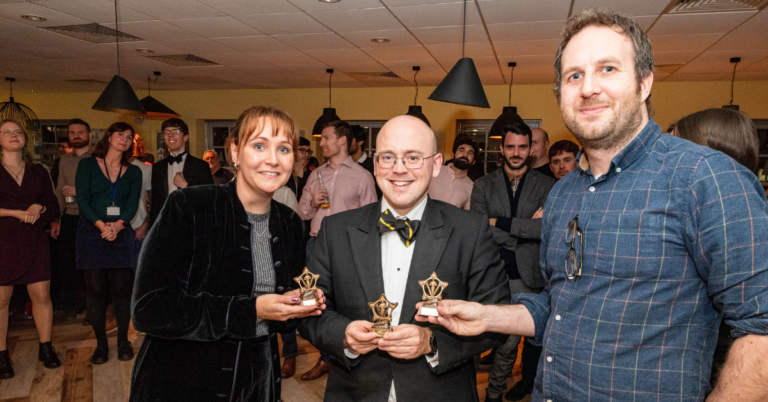 Principal Application Scientist, Grace Kocks and Principal Scientist, David Ponting being presented their trophy by Director of Science, Adrian Fowkes.